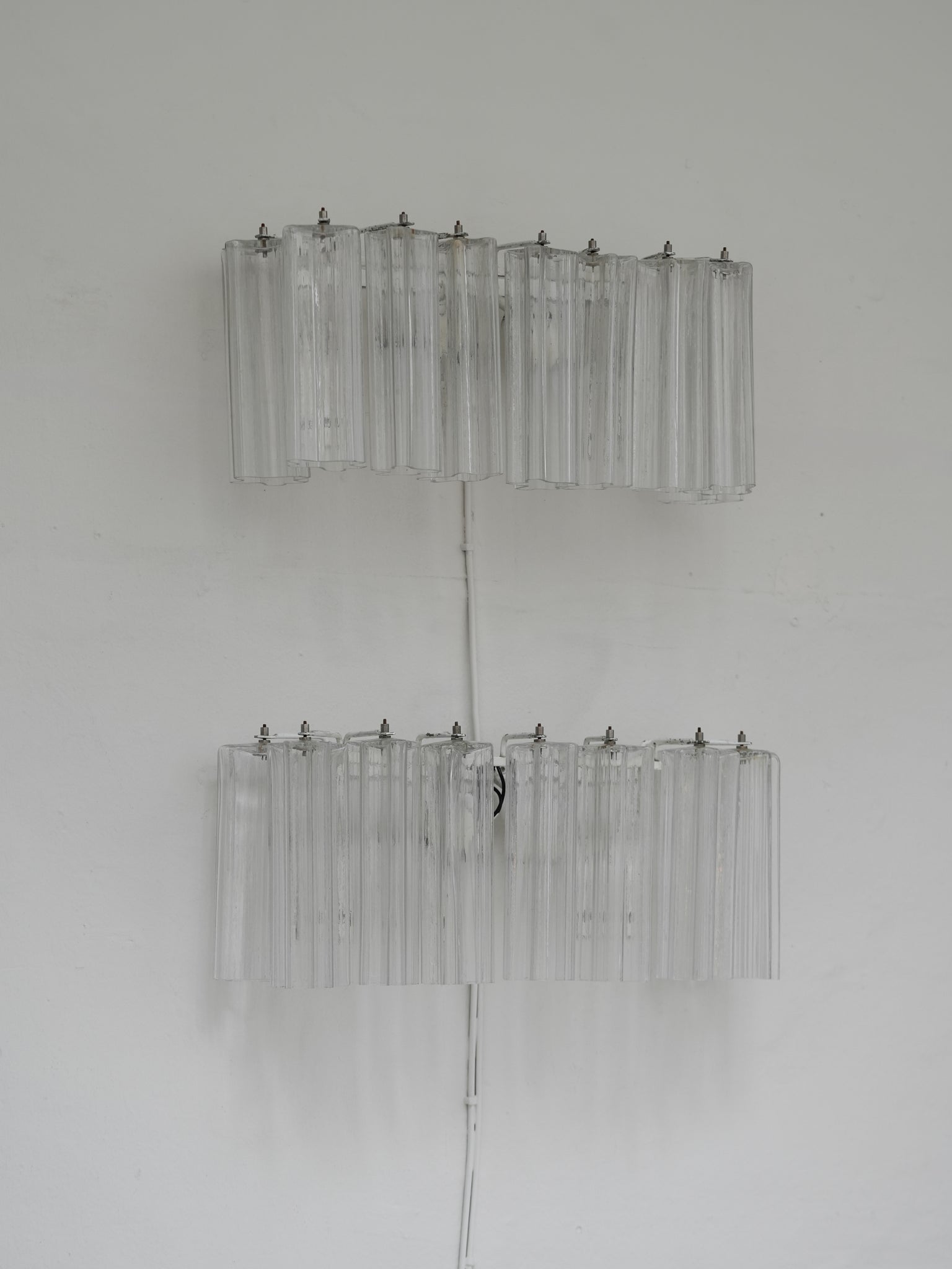 Pair of vintage Venini wall lights in clear Murano glass with a metal frame, crafted in Italy, 1960s. Available at RUE VERTE, Copenhagen's destination for vintage and contemporary art, lighting and furniture.