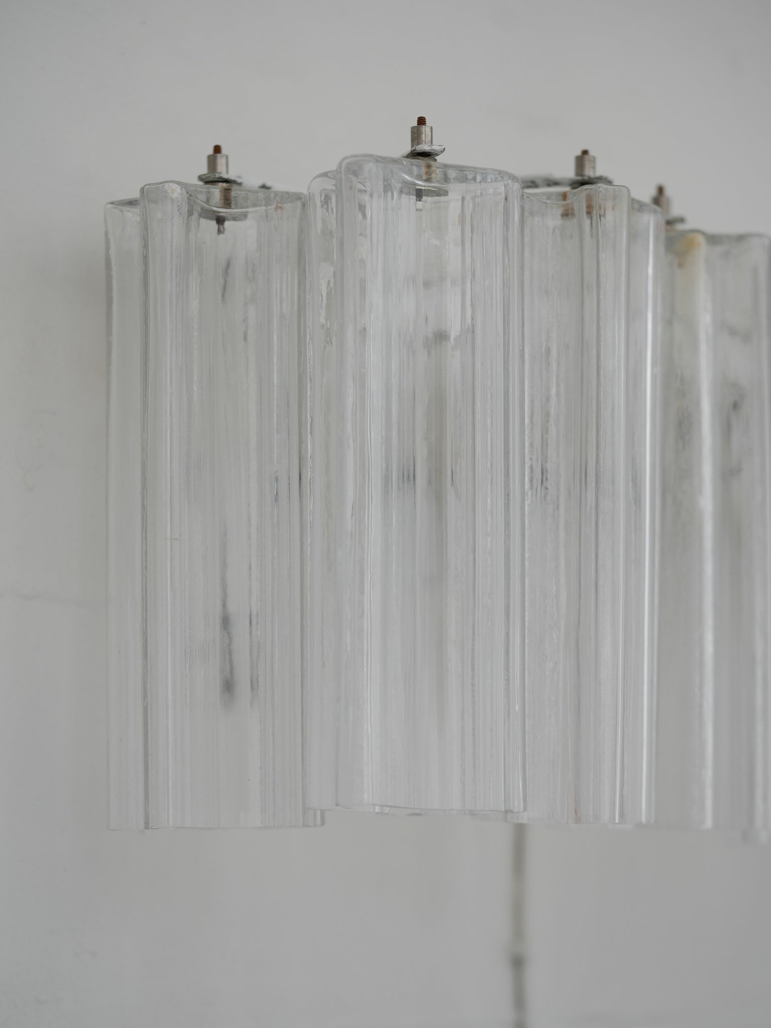 Pair of vintage Venini wall lights in clear Murano glass with a metal frame, crafted in Italy, 1960s. Available at RUE VERTE, Copenhagen's destination for vintage and contemporary art, lighting and furniture.