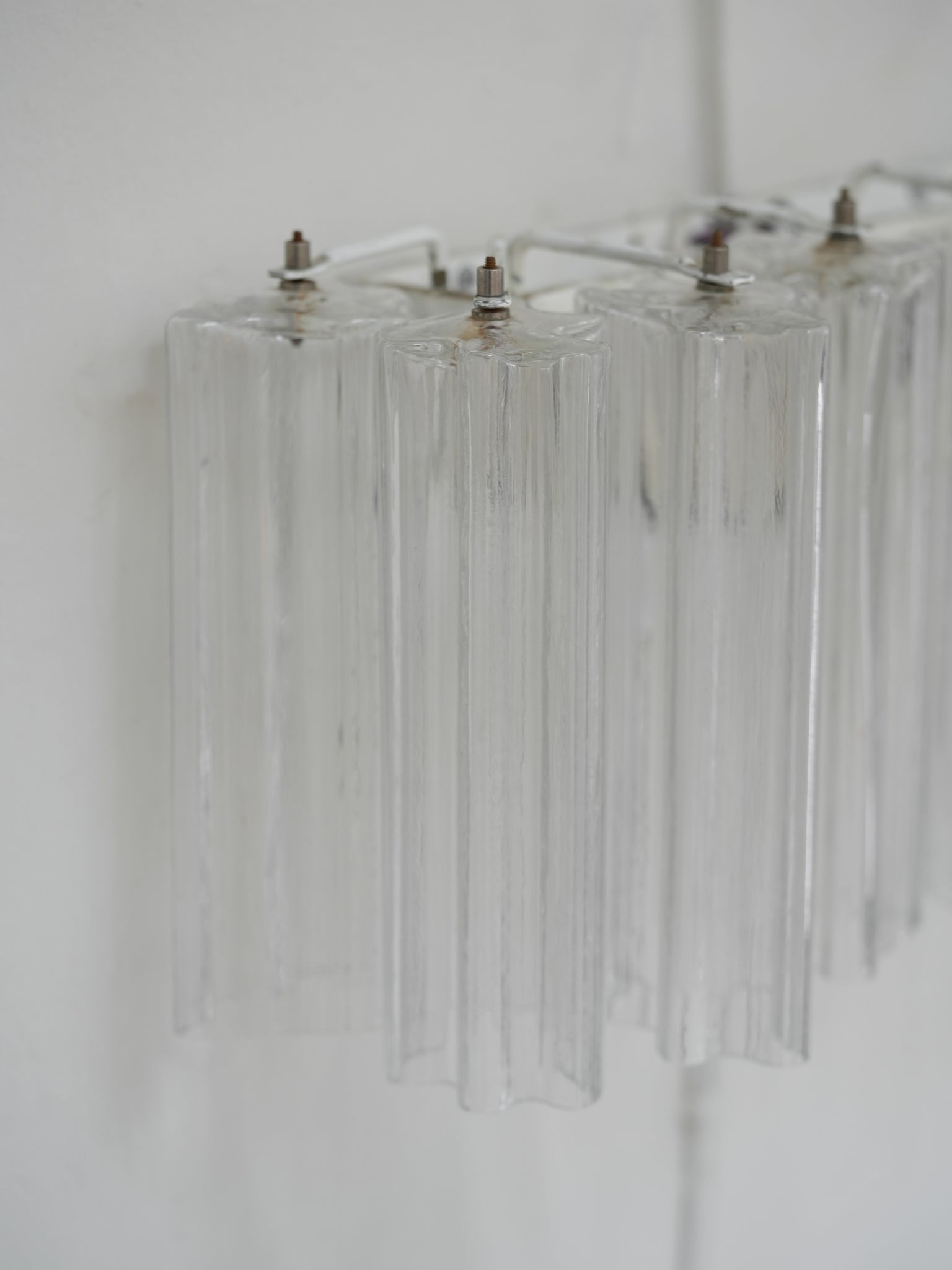 Pair of vintage Venini wall lights in clear Murano glass with a metal frame, crafted in Italy, 1960s. Available at RUE VERTE, Copenhagen's destination for vintage and contemporary art, lighting and furniture.